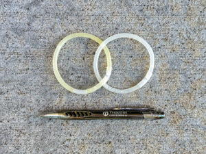 Two interlocking glow stick bracelets and a pen with TitleOne logo