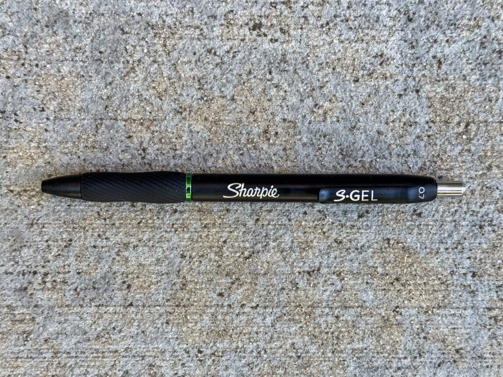 Black Sharpie S-Gel pen with a 0.7mm tip and green ink, as indicated by the green collar above the grip