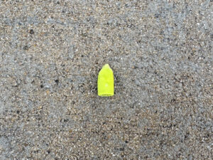 Well-worn fluorescent yellow eraser cap.