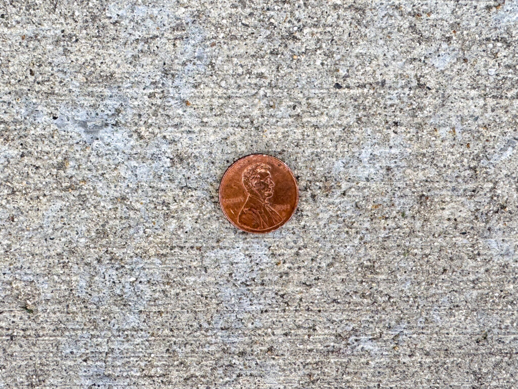 Close-up of a 2012 U.S. penny lying heads-up, showing Abraham Lincoln's profile.