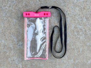 A clear waterproof phone pouch with a hot pink seal labeled “FUN-BAG”, attached to a black lanyard.