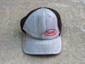 Gray Peterbilt trucker hat with a red embroidered logo, black mesh back, curved brim, and light wear on the front panels.
