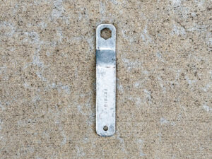 Scuffed silver Makita 13 mm offset wrench, part 782016-4, with a hexagonal opening at one end and a small hanging hole at the other.