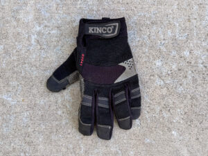 Black and gray KincoPro #2041 left work glove with reinforced fingertips and an adjustable wrist strap.